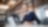 Mid adult business professional sitting at table with laptop and talking on mobile phone. Businessman working in office.